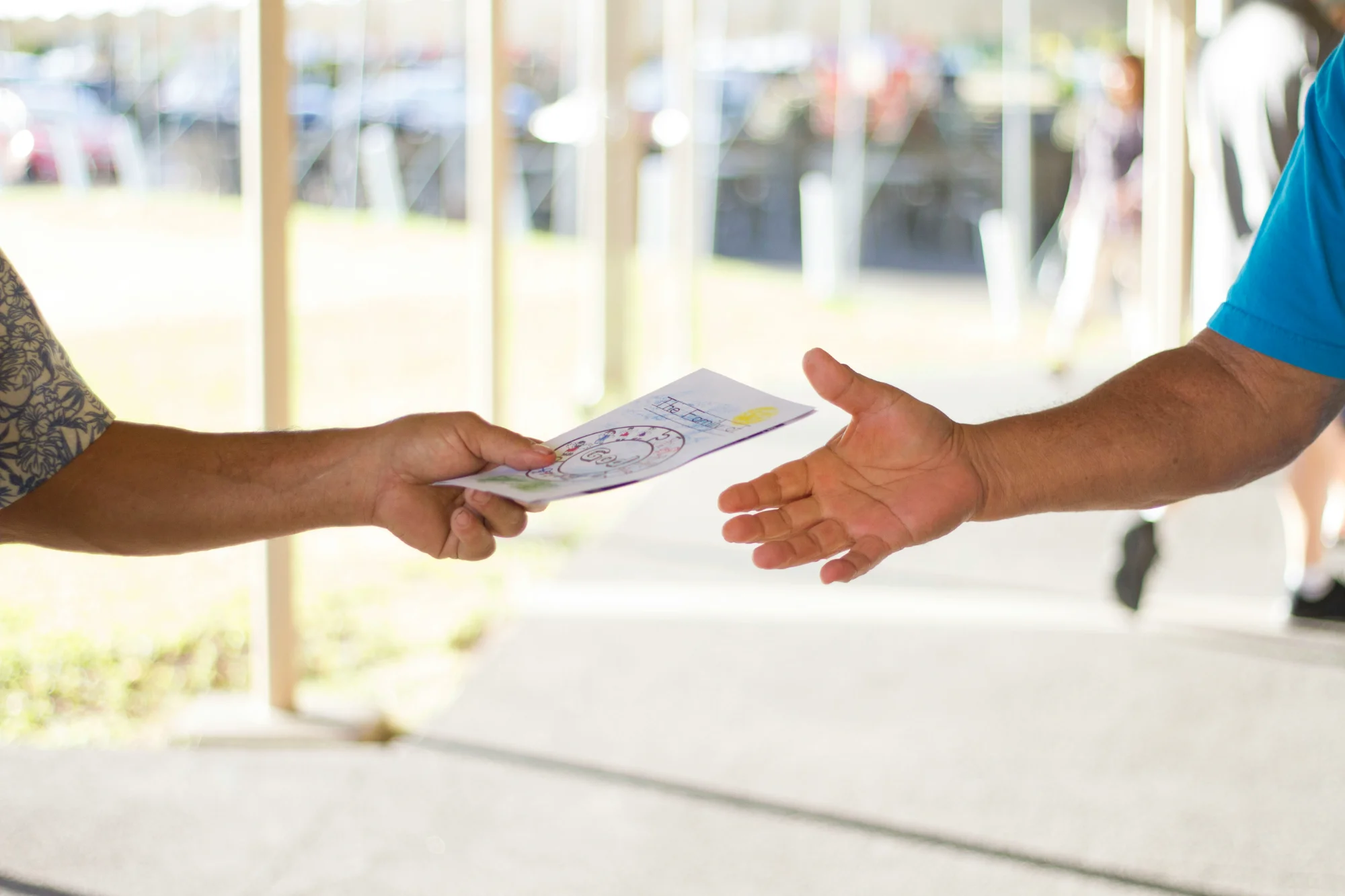 Hands giving offering envelope representing church giving and generosity
